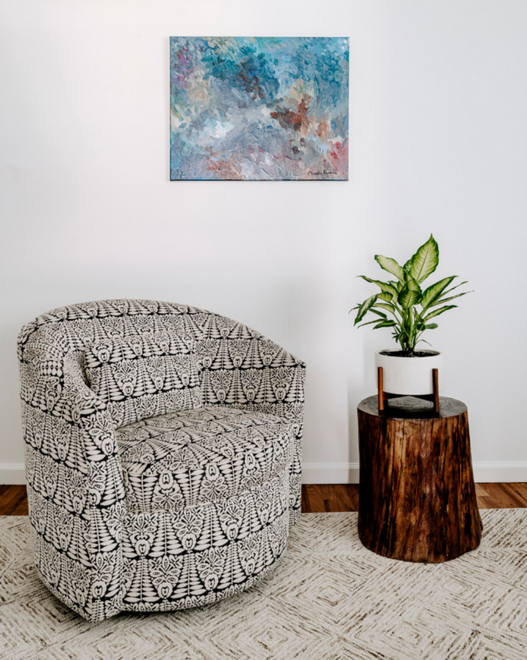 <img src="blackandwhiteikatchair_projects.png" alt="Black and white ikat swivel chair by Rogala Design with colorful art and stump side table with plant ">