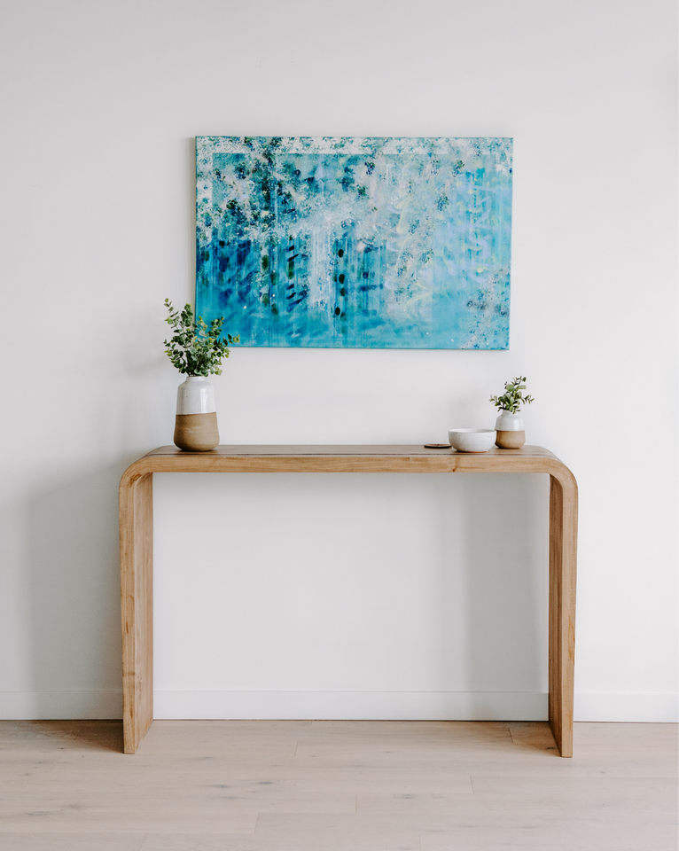 <img src="waterfallconsoletablewithblueart_projects.png" alt="Rogala Design waterfall console table with blue abstract art and plants">
