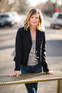 <img src="amyrogalaheadshot_meetamypage.jpg" alt="Headshot of designer Amy Rogala in black blazer leaning on custom metal console table">