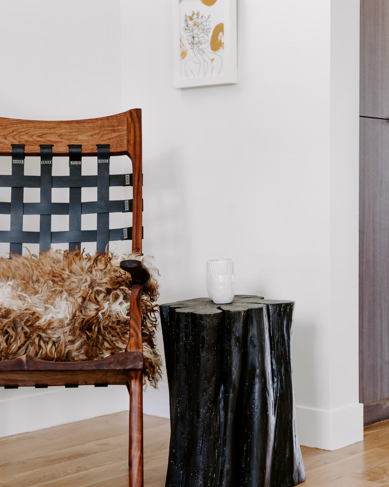 <img src="brownandblackwovenchairwithstump_projects.png" alt="Wooden chair with black woven leather featuring Rogala Design brown sustainable sheep fur pillow and live edge side table ">