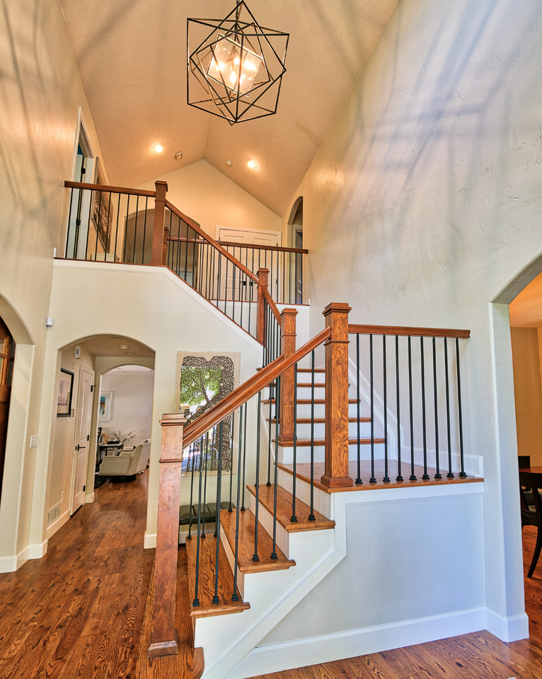<img src="entryway_projects.png" alt="White and walnut entryway with stairs, black iron banister, and farmhouse pendant light fixture">