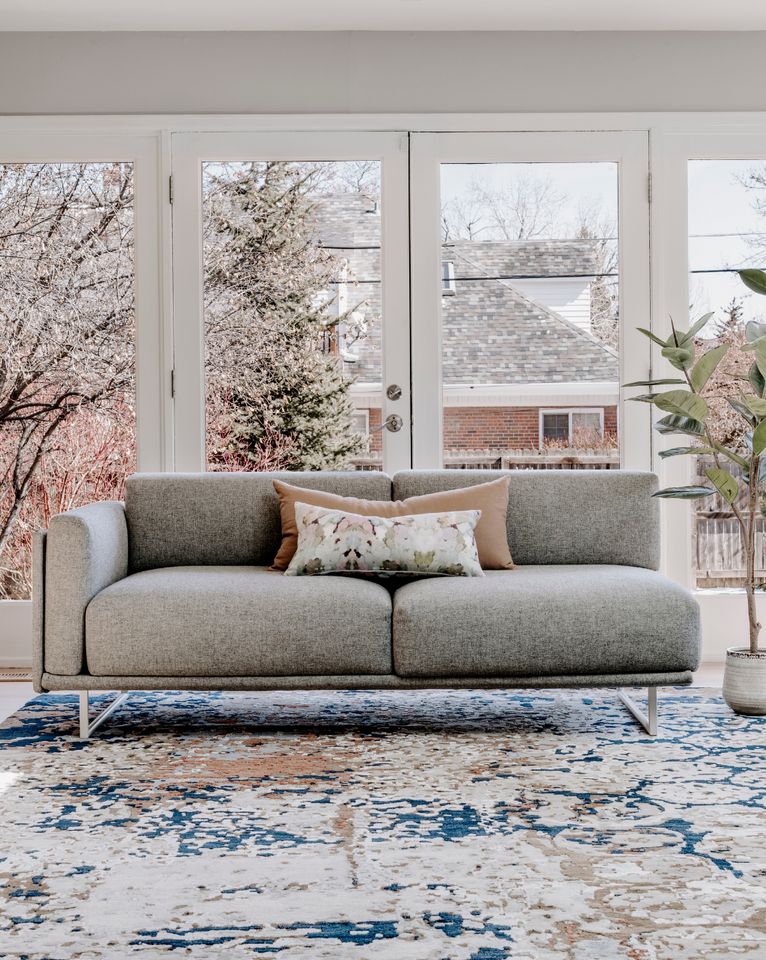 <img src="livingroomwithgreysofaandpastelfloralaccents_projects.png" alt="Living room featuring a light grey sofa with pastel floral throw pillows and area rug">