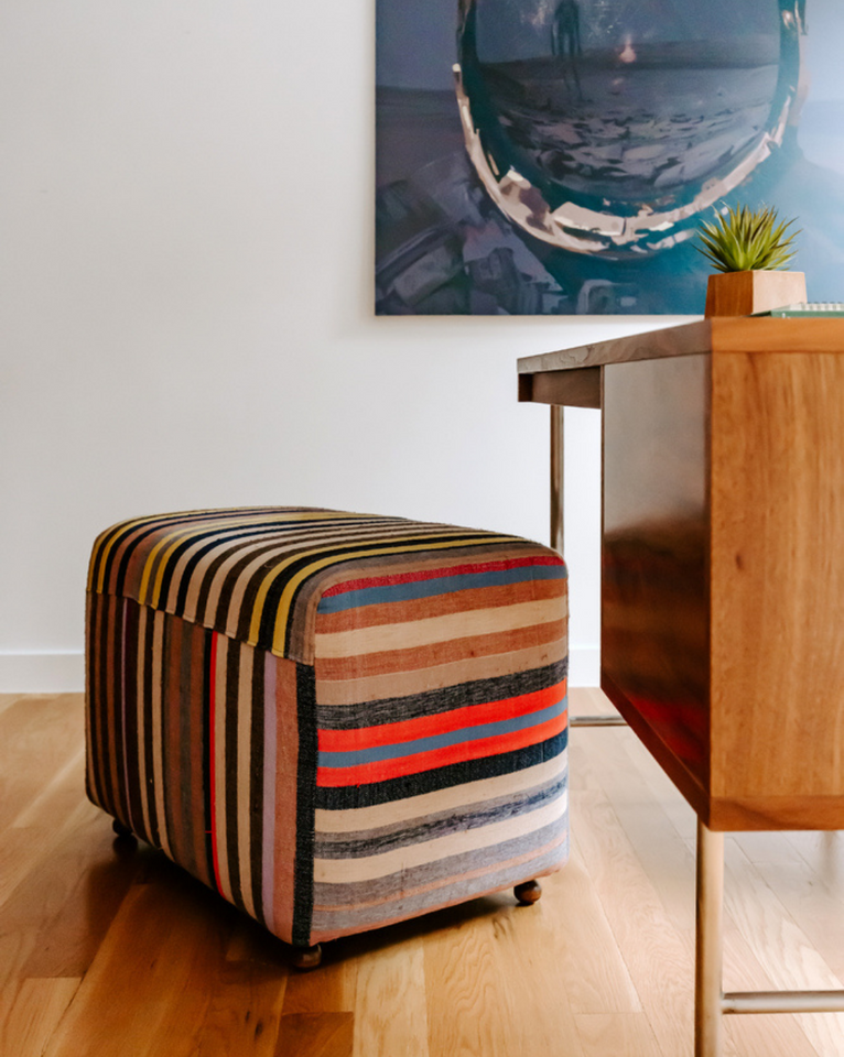 <img src="multicolorstripecubeottoman_projects.png" alt="Rogala Design multicolor cube ottoman under walnut desk and blue art">